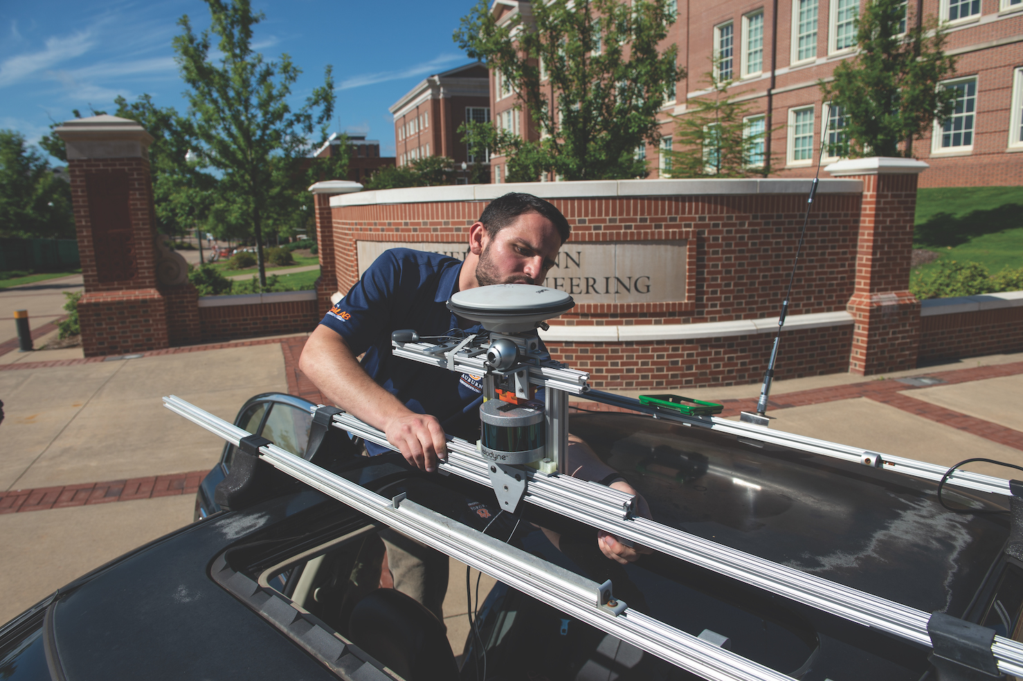 An Auburn University engineering student works on truck platooning equipment. 