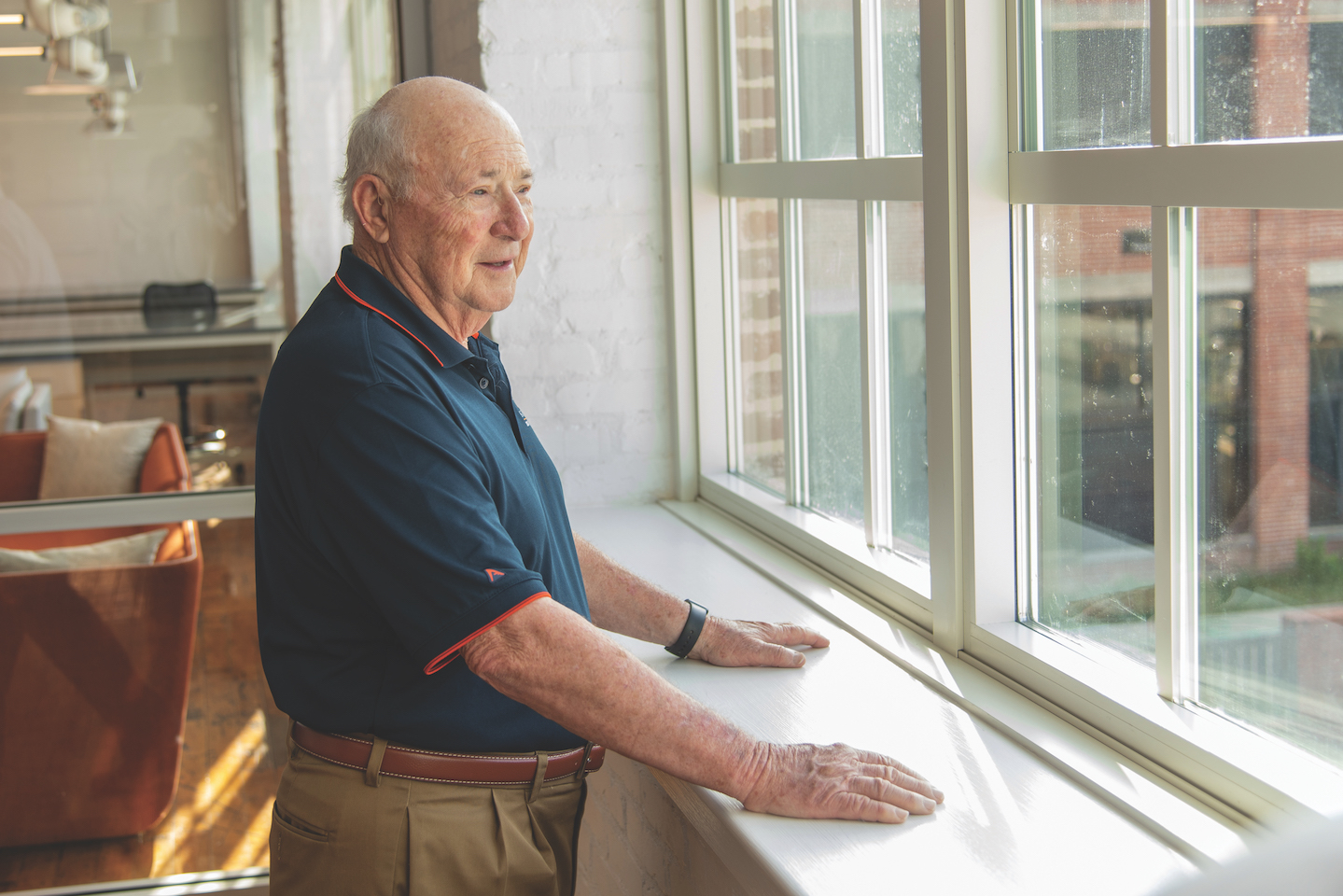 Charles Gavin, ’59 textile management, takes a look out the window of the newly renovated Gavin Engineering Research Laboratory overlooking the Carol Ann Gavin Garden, which is currently under construction.
