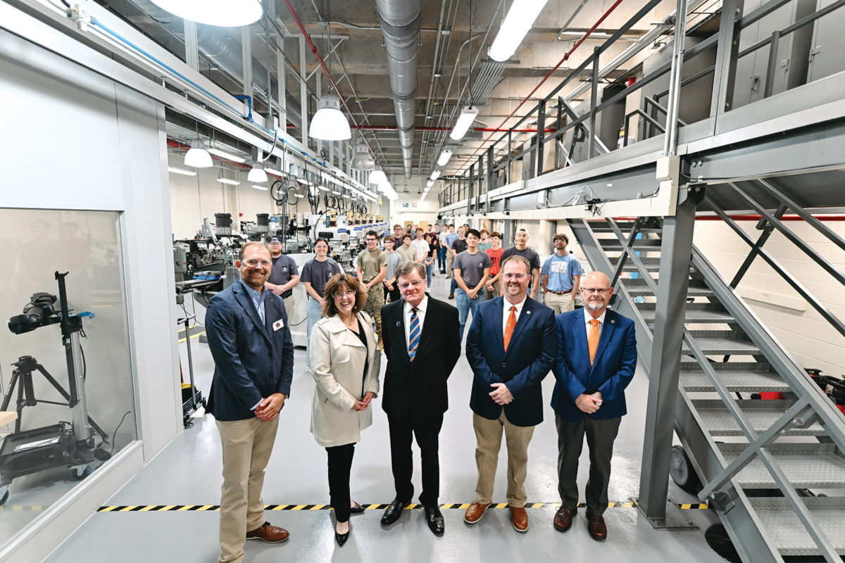 Front, from left: Christian Brodbeck, director of engineering research
operations; Montgomery Family Foundation principals Mary and
Larry Montgomery; Jordan Roberts, senior engineering lecturer; and
Mario Eden, dean of engineering, tour the new and improved Design
and Manufacturing Laboratory, which anchors the recently renovated
Montgomery Advanced Manufacturing Laboratories in the basement of
Wiggins Hall.