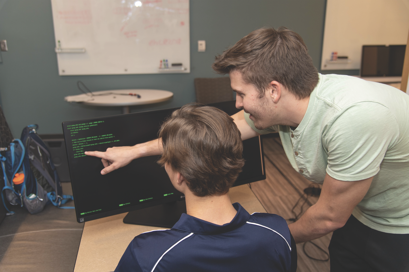 Auburn students studying computer code. 