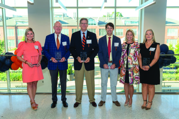 The 2022 Auburn Alumni Engineering Council award winners included Outstanding Young Auburn Engineer Kelly Roberts, ’05 and ’07 civil engineering; Distinguished
Auburn Engineer Jim Cooper, ’81 civil engineering; Distinguished Auburn Engineer John MacFarlane, ’72 mechanical engineering; Outstanding Young Auburn Engineer
McClain Towery, ’03 civil engineering; Distinguished Auburn Engineer Nicole Faulk, ’96 and ’99 mechanical engineering; and Superior Service Angie Lemke, retired,
dean’s assistant. Not pictured is Distinguished Auburn Engineer TK Mattingly, ’58 and ’86 aerospace engineering.